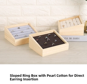 Detail of wooden jewelry display trays with multi-slot liners for rings and earrings