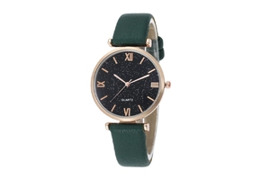 Detail of starry black dial with Roman numerals and dark green leather watch strap