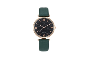 Close-up of starry sky dial with Roman numerals and green leather strap on quartz watch