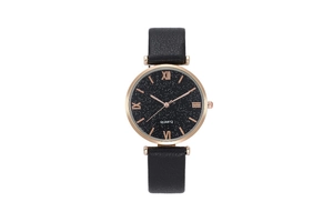 Detail of rose gold case and black starry sky dial with Roman numerals on quartz watch
