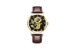 Detailed macro of golden dragon dial design and crystal markers on mens leather watch