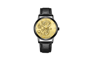 Macro shot of golden dragon relief dial with crystal markers on black leather watch