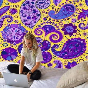 Detail of bohemian paisley wall tapestry featuring vibrant purple and yellow mandala patterns
