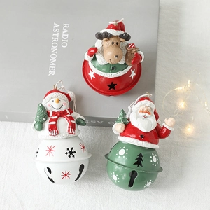 Three festive metal Christmas bells featuring Santa, reindeer, and snowman figurines