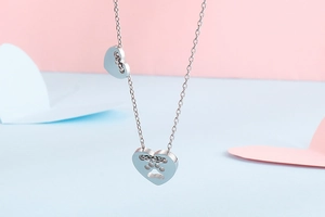 Dettaglio del ciondolo a cuore in argento con un simpatico design a zampa traforata