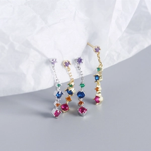 Macro detail of S925 sterling silver drop earrings with multi-color zircon tassels