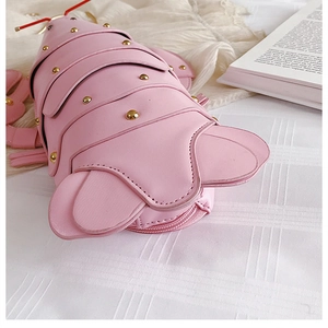 Detail of pink lobster bag showing faux leather texture and gold stud accents