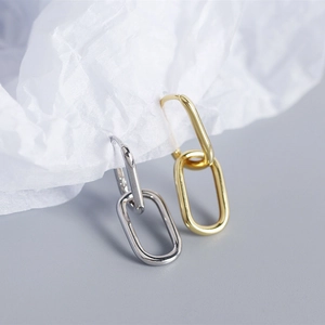 Close-up of interlocking gold and silver oval S925 sterling silver earrings