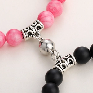 Close-up of pink marble and matte black beads with silver magnetic heart clasp
