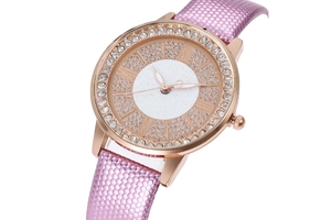 Detail of rose gold watch bezel with crystals and purple honeycomb textured strap