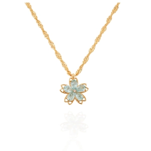 Detail of light blue crystal flower pendant with gold twisted chain on white background