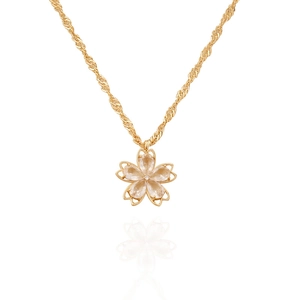Detail of gold cherry blossom pendant featuring sparkling crystals on a twisted wave chain