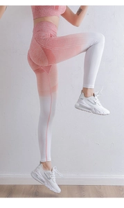 Detail view of red and white gradient high waist yoga pants with seamless mesh texture