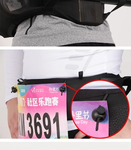 Detail view of black running belt featuring breathable mesh and marathon bib number clips
