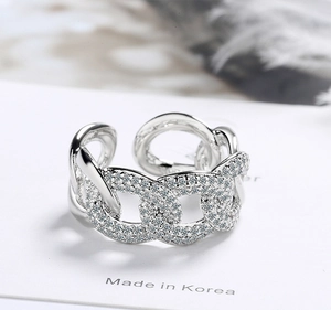Macro shot of silver micro-paved chain link open ring with sparkling crystals