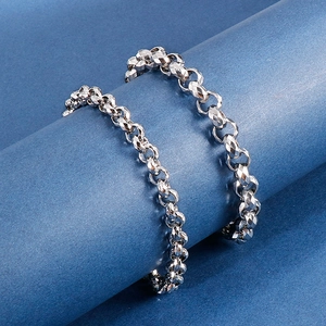Detailed macro view of silver geometric faceted chain links with metallic reflections