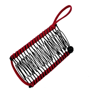 Close-up of black mesh banana hair clip with red elastic frame for bun styling