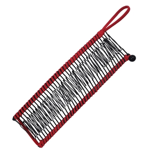 Detail of black metal wire banana hair clip with red woven cord and beaded buckle