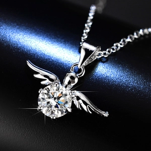 Macro shot of 1ct moissanite necklace with angel wing pendant on black leather