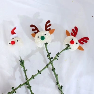 Detail of handmade Santa and reindeer flower decorations for Christmas DIY bouquets