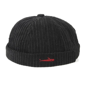 Close-up of black corduroy docker hat featuring a small red fish embroidery detail