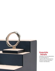 Side view of dual-tone metal watch band on display stand with minimalist background