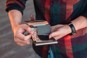 Slim brown leather card holder wallet with aluminum pop-up case and money clip detail