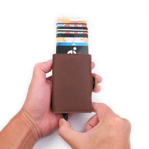 Detailed view of brown PU leather card holder showing automatic pop-up card mechanism
