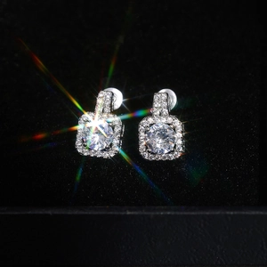 Macro view of square halo stud earrings with round center stone and pave zircon setting