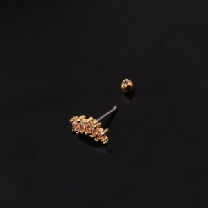 Detail of gold cartilage stud featuring five marquise iridescent stones on black background