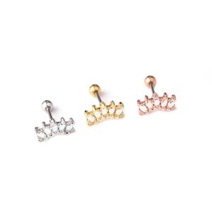 Three surgical steel cartilage studs in silver, gold, and rose gold with opal stones