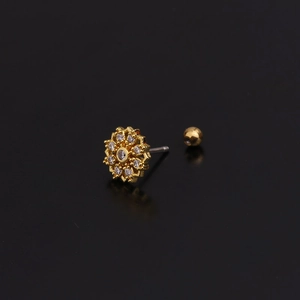 Macro shot of gold floral tragus piercing stud with clear zircon on a black reflective surface