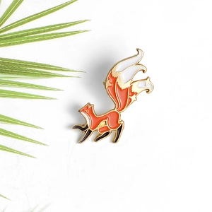 Charming red and white enamel fox brooch pin with gold metal outlines on white background