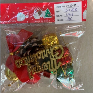 Close-up of Christmas tree ornaments including golden signs and festive pine cones