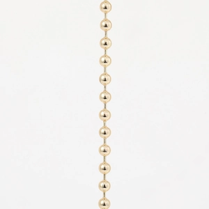 Detailed macro view of high-quality polished golden brass ball chain for DIY jewelry