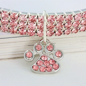 Detailed view of pink rhinestone pet collar with sparkling claw-shaped pendant