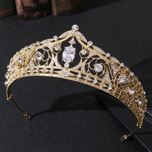 Close-up of golden bridal tiara with sparkling zircon crystals and intricate filigree details