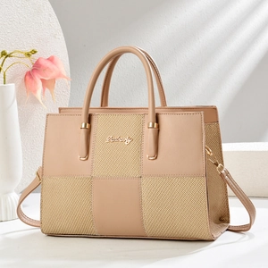 Detail of nude tote bag showing premium leather stitching and woven texture accents