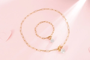 Detail of gold chain necklace and bracelet set with rhinestone balls and OT toggle clasps