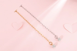 Detailed view of gold and silver square chain necklaces with crystal ball charms and OT buckles