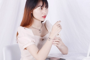 Silver heart pendant necklace and bracelet set shown on model with OT buckle design