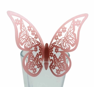 3D pearlescent paper hollow butterfly decoration in pink on a glass rim