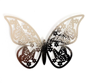 Close-up of 3D ivory pearlescent paper butterfly with intricate hollow laser-cut patterns