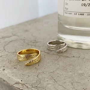 Macro shot of gold and silver S925 sterling silver rings with hammered texture and S925 stamp