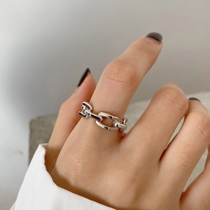 Macro detail of minimalist 925 sterling silver chain ring with industrial textured finish