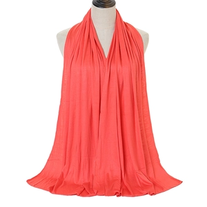 Detail of coral pink mercerized cotton shawl showing soft texture and fine stitching