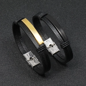 Detail of black leather men's bracelets with gold and black stainless steel plates