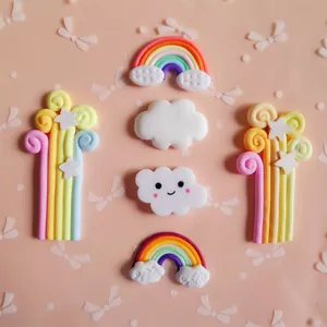 DIY colorful clay rainbow and clouds keychain accessories on pink bow background
