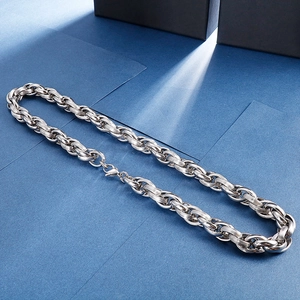 Macro detail of silver steel link chain with brushed metal texture and industrial design