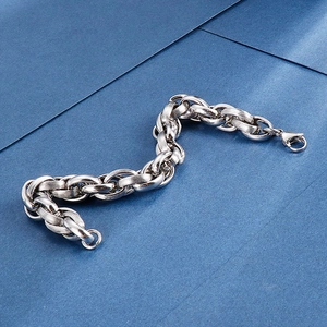 Silver stainless steel industrial textured chain bracelet with lobster clasp on blue